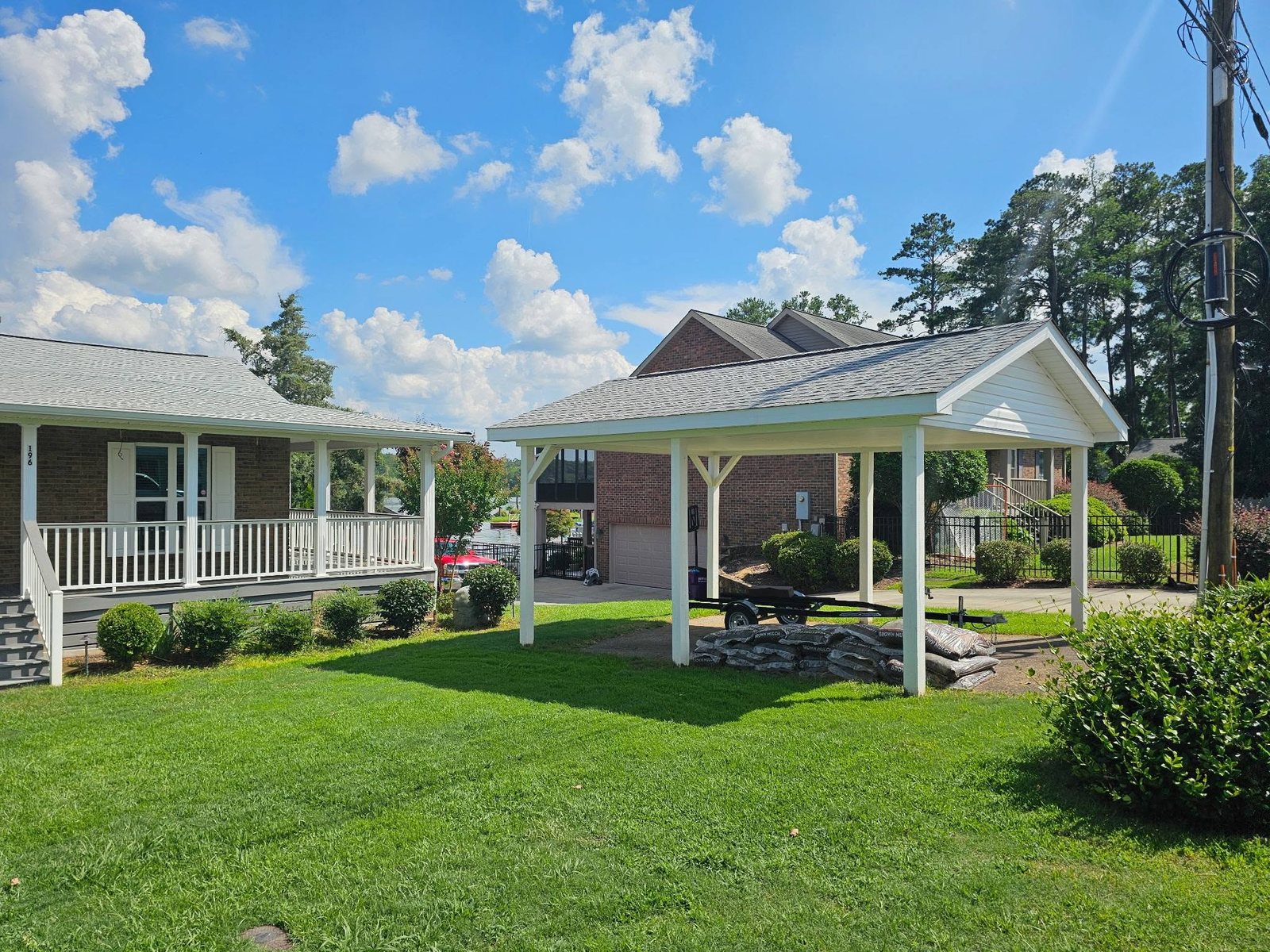 Brick home with covered breezeway and manicured lawn, a property serviced by C.C. Pressure Washing