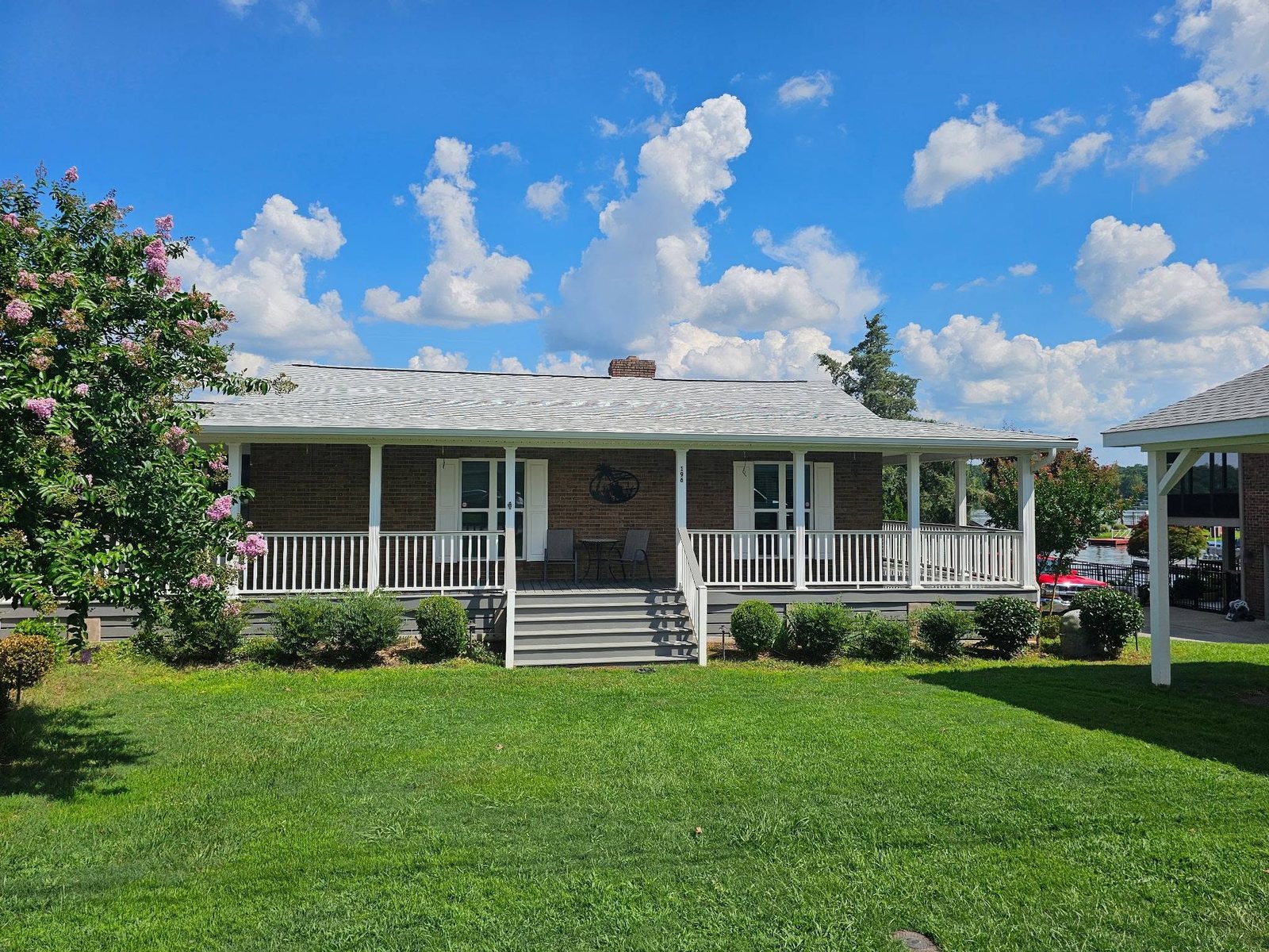 Brick ranch home with wraparound porch, a property serviced by C.C. Pressure Washing