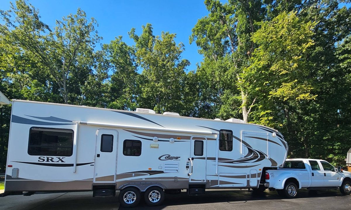 Clean RV camper after pressure washing, parked in driveway